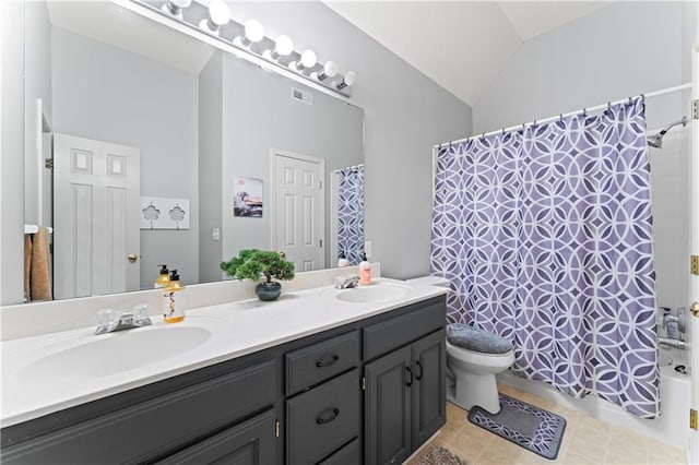 bathroom featuring tile patterned flooring, vanity, toilet, and vaulted ceiling