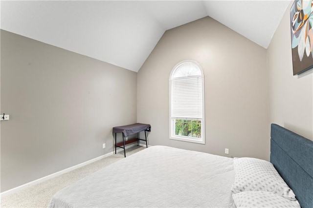 bedroom with carpet flooring and vaulted ceiling