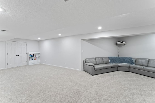 unfurnished living room with carpet flooring and a textured ceiling