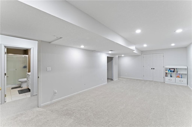 basement featuring light carpet