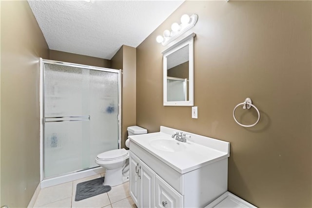 bathroom with vanity, tile patterned floors, toilet, a textured ceiling, and an enclosed shower