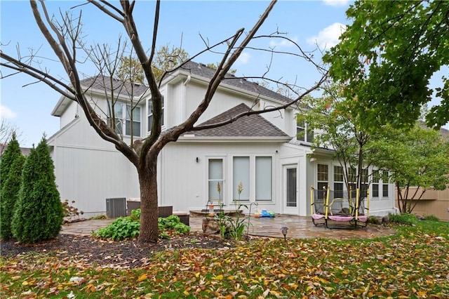 rear view of property featuring a patio area and central AC