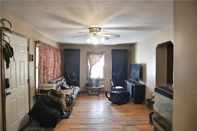 interior space featuring wood-type flooring and ceiling fan