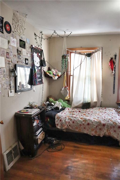 bedroom with hardwood / wood-style floors