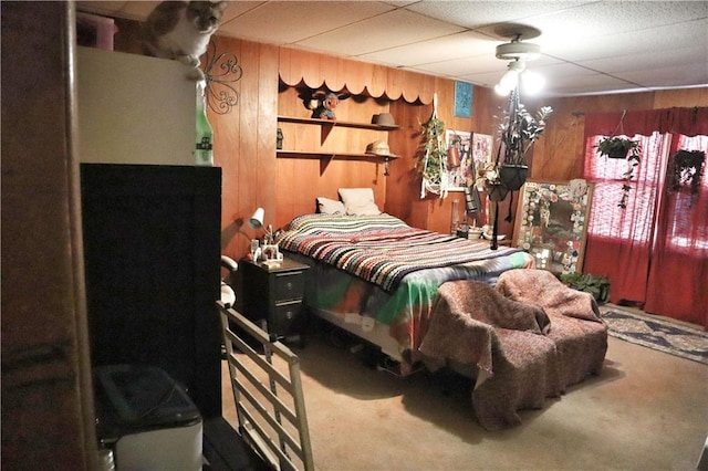 bedroom with carpet floors and wooden walls