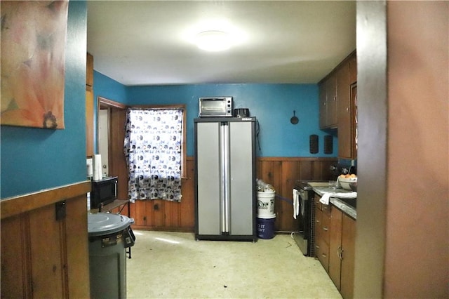 kitchen with wooden walls and range