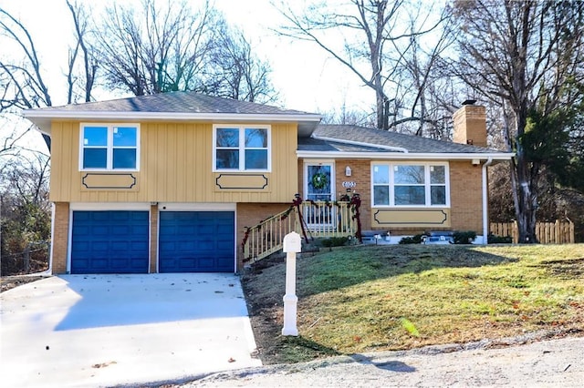 tri-level home with a garage and a front lawn