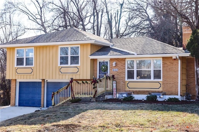 tri-level home featuring a garage and a front yard