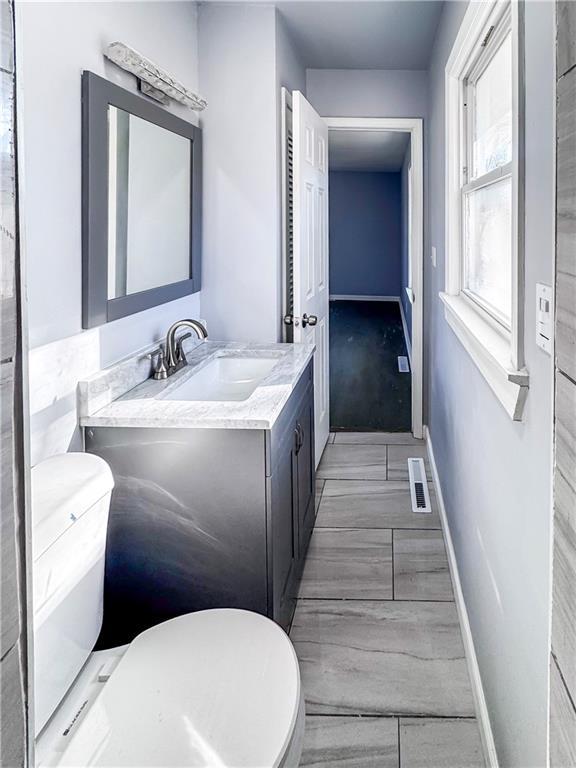 bathroom with vanity and toilet