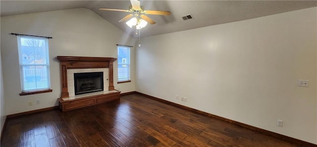 unfurnished living room featuring ceiling fan, dark hardwood / wood-style flooring, lofted ceiling, and a fireplace