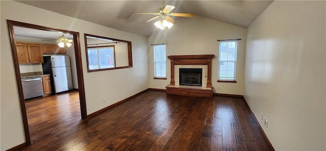 unfurnished living room featuring dark hardwood / wood-style flooring, ceiling fan, a fireplace, and lofted ceiling