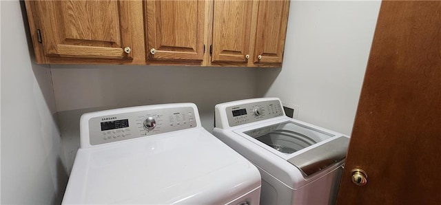 laundry area featuring cabinets and washing machine and clothes dryer