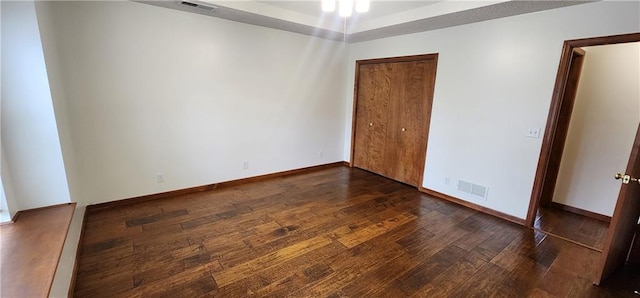 empty room featuring dark hardwood / wood-style flooring