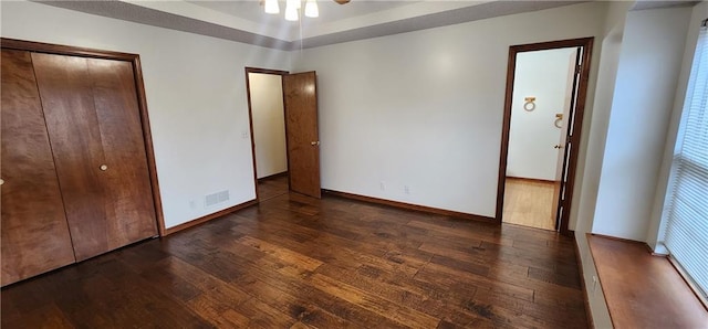 unfurnished bedroom with dark hardwood / wood-style flooring