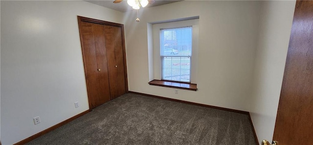 carpeted spare room with ceiling fan