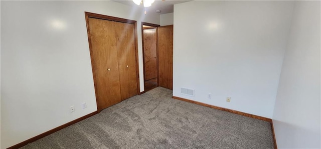 unfurnished bedroom with light colored carpet and a closet