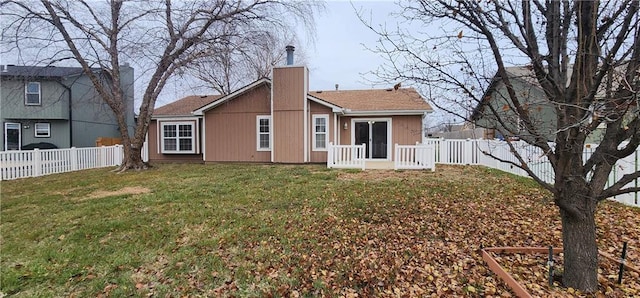 rear view of house with a lawn