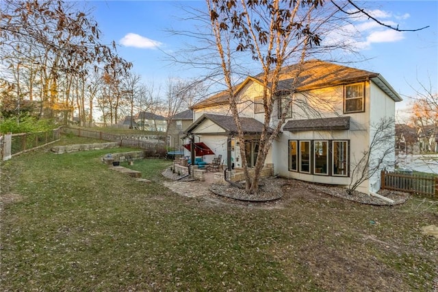 back of property featuring a yard and a patio