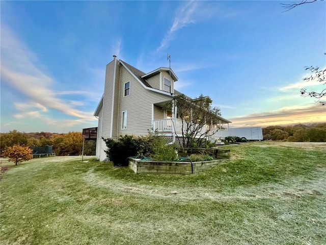 property exterior at dusk with a lawn