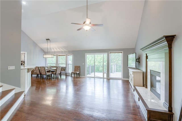 6764 Longview Rd, Shawnee, KS 66218 - living area featuring high vaulted ceiling, baseboards, dark wood-type flooring, a ceiling fan, and stairway