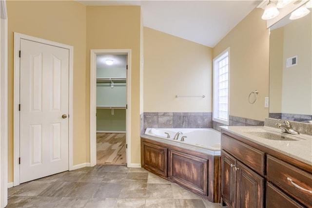 6764 Longview Rd, Shawnee, KS 66218 - bathroom with a bath, vanity, and a spacious closet