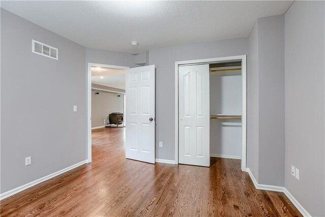 6764 Longview Rd, Shawnee, KS 66218 - unfurnished bedroom featuring wood finished floors, a closet, and baseboards