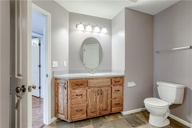 6764 Longview Rd, Shawnee, KS 66218 - bathroom featuring vanity, toilet, and baseboards