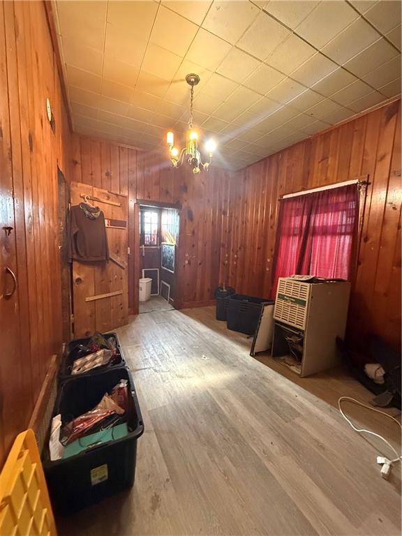 interior space with hardwood / wood-style floors and an inviting chandelier