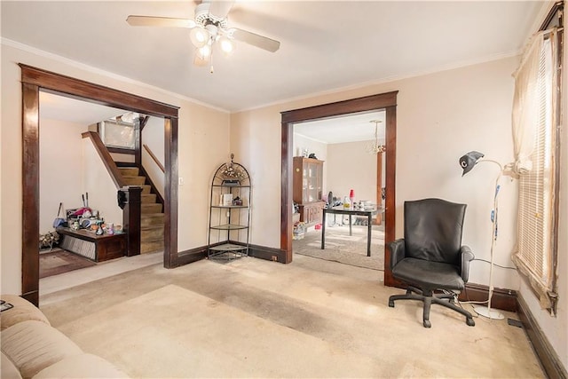 interior space featuring ceiling fan with notable chandelier, light colored carpet, and ornamental molding