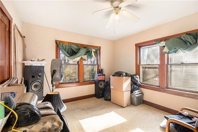 interior space featuring ceiling fan and light colored carpet