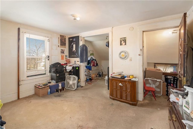 misc room with light colored carpet and vaulted ceiling