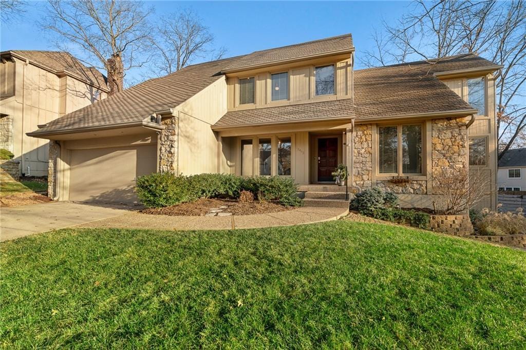 view of front of home with a garage and a front yard