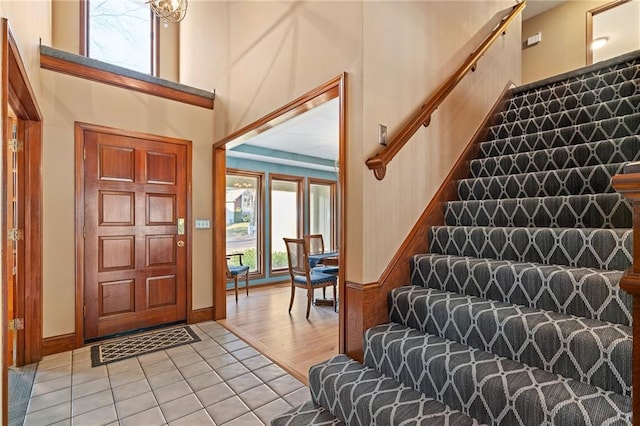 tiled entryway with a towering ceiling