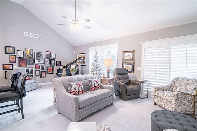 living room featuring ceiling fan, light carpet, and high vaulted ceiling