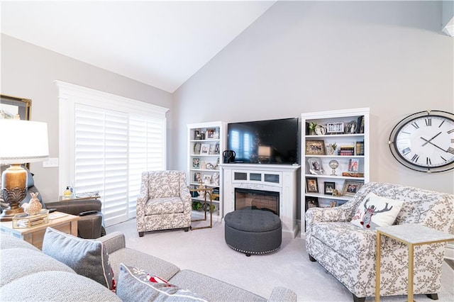 living room with carpet flooring, a fireplace, and high vaulted ceiling