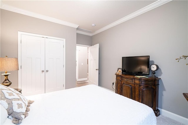 carpeted bedroom with a closet and ornamental molding