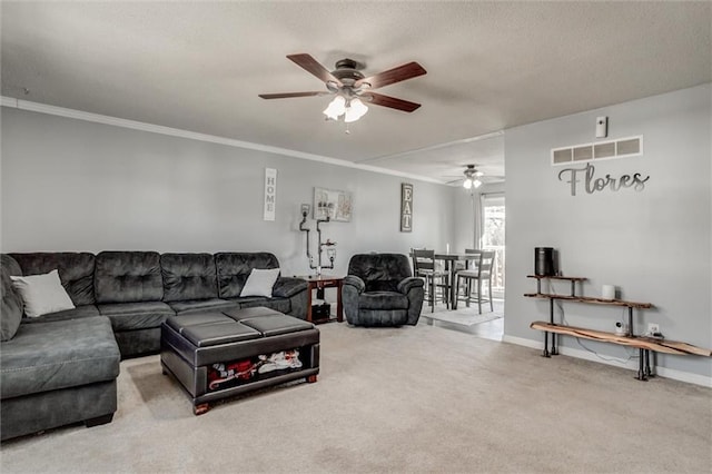 living room featuring ceiling fan, carpet floors, visible vents, baseboards, and crown molding