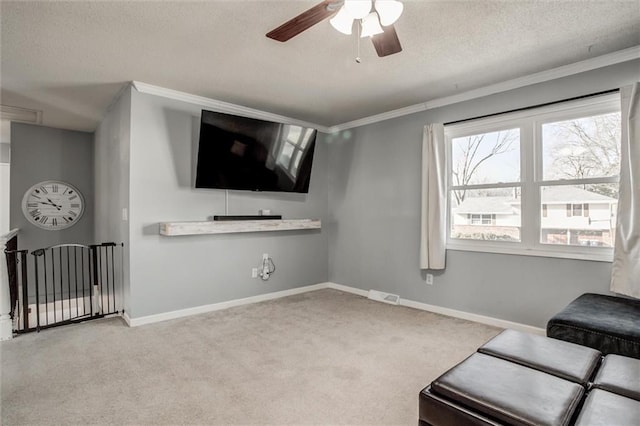 living area with light carpet, a textured ceiling, visible vents, and baseboards