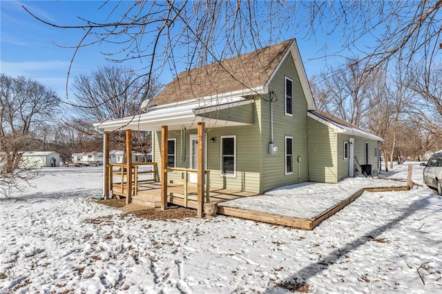 snow covered property featuring a porch