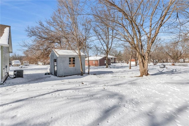 snowy yard with central AC