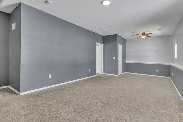 spare room featuring ceiling fan and carpet