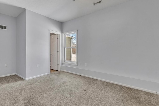 unfurnished room featuring light carpet