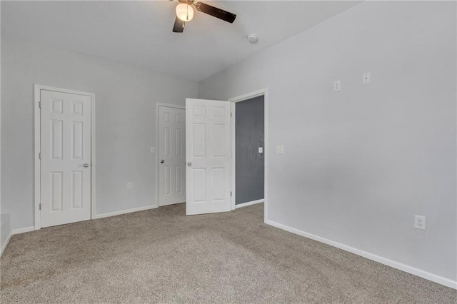 empty room featuring ceiling fan and carpet floors