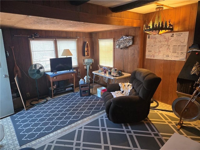 living room featuring wood walls and beamed ceiling