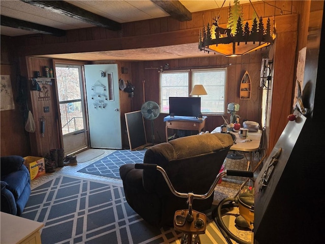 living room with beam ceiling and wooden walls