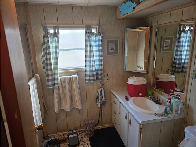 bathroom featuring vanity and wooden walls