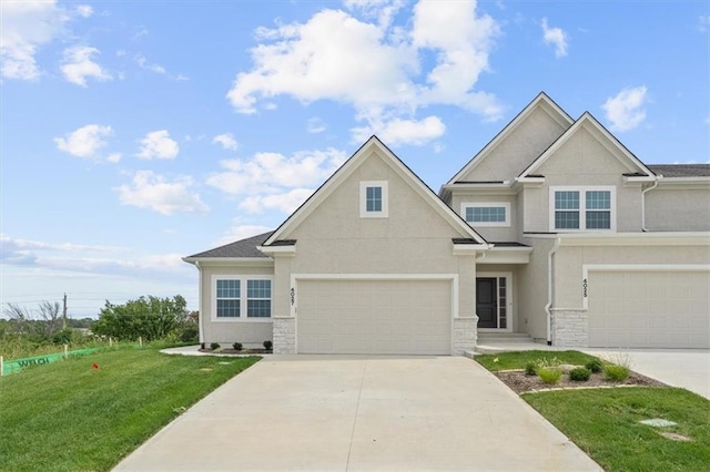 view of front of home with a front yard and a garage