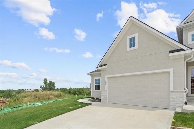 view of side of home featuring a garage and a yard