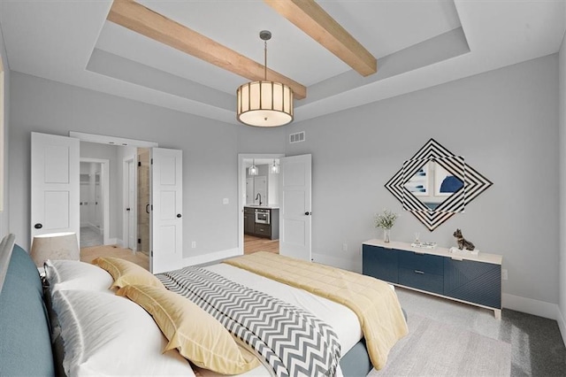 carpeted bedroom featuring sink and beamed ceiling