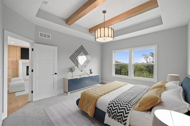 carpeted bedroom with beam ceiling